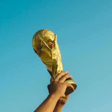 person holding gold trophy