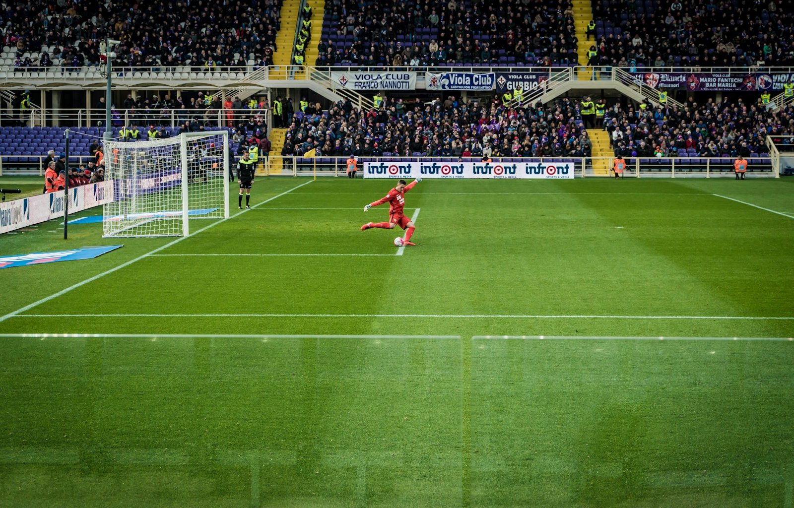 people playing soccer on field during daytime