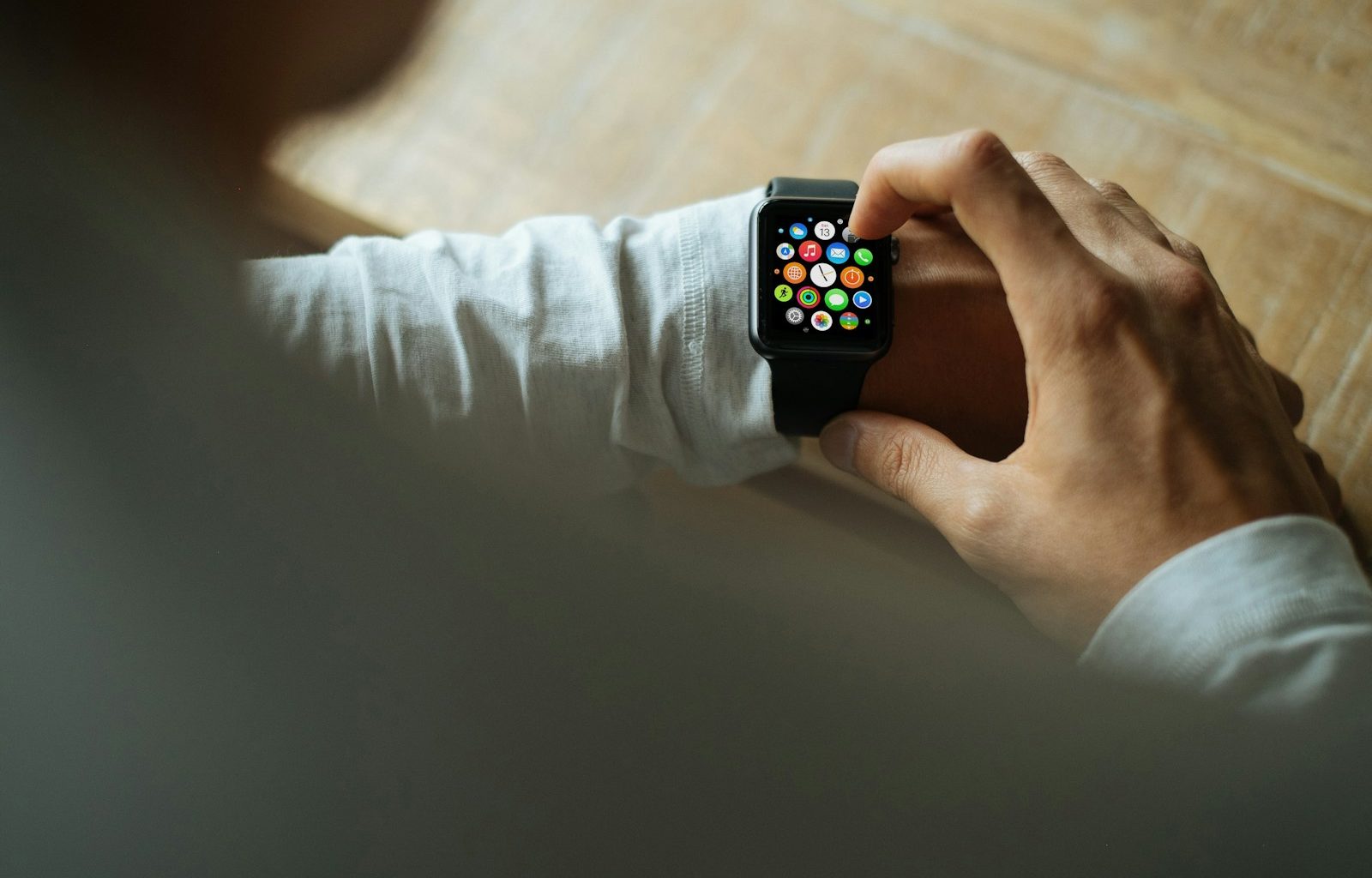 person holding Apple Watch with black Sport Band