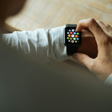 person holding Apple Watch with black Sport Band