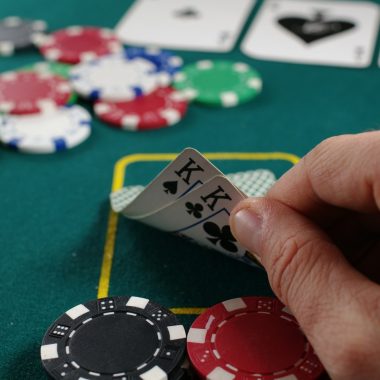 person holding white and black playing cards