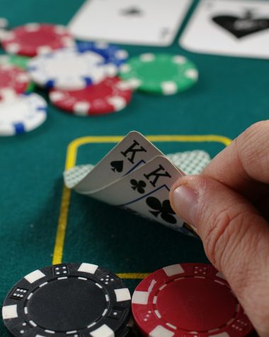 person holding white and black playing cards
