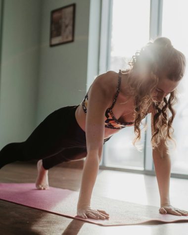 woman in black tank top and black leggings doing yoga