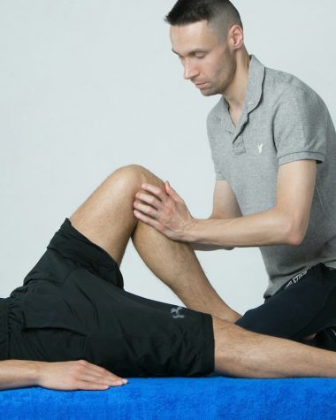 a man getting his leg examined by a doctor