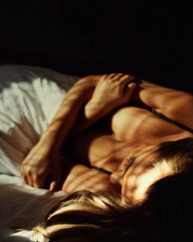 a woman laying on top of a bed next to a man