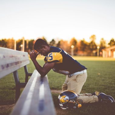 baseball player kneeling on ground